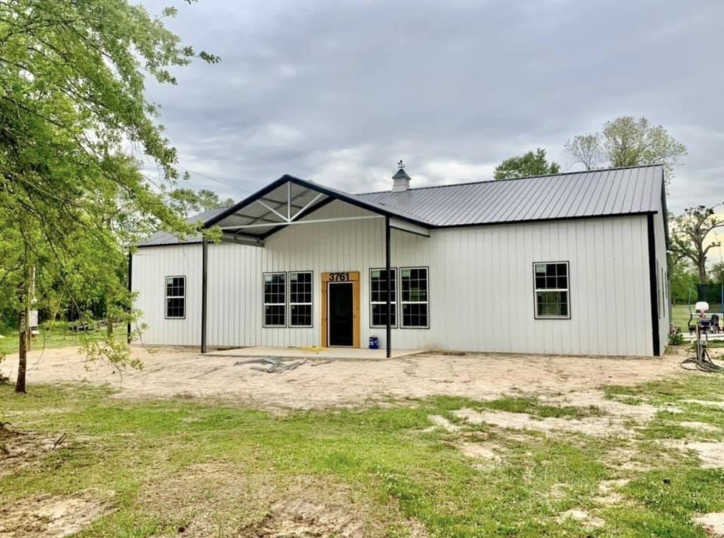 Patriot barndominium with porch and windows